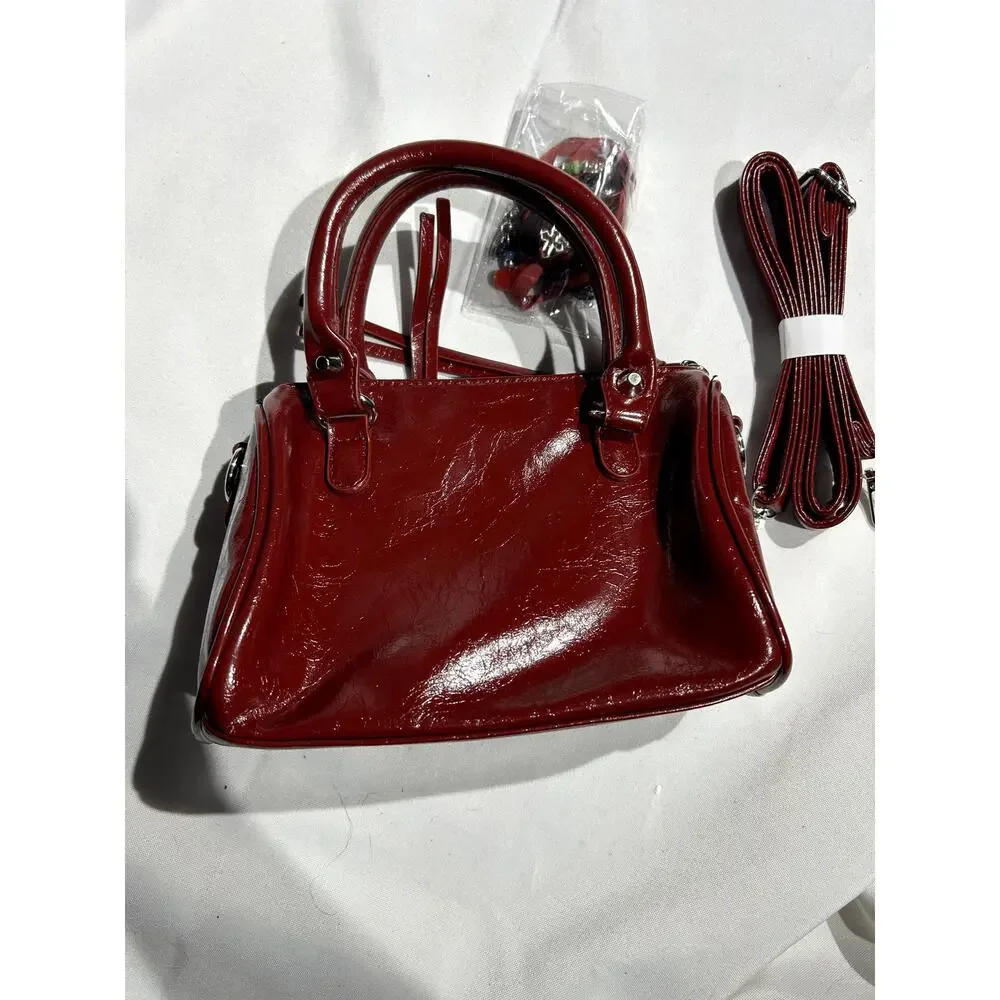 NWOT Deep Red Vegan Leather Handbag with Crossbody Strap and‎ Bag charms
